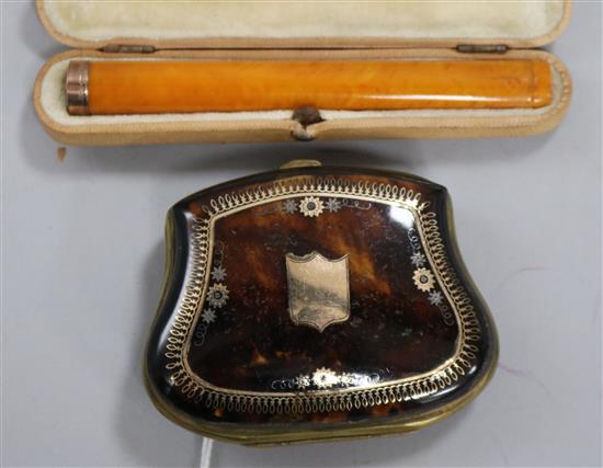 A gold inlaid brass mounted tortoiseshell purse and a gold mounted amber cheroot holder.